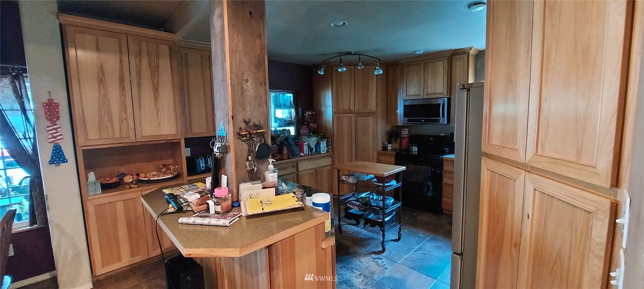 330 Shamrock Road Longview, WA 98632 - Photo 6 of 18 a view of kitchen island with stainless steel appliances wooden floor dining table and chairs