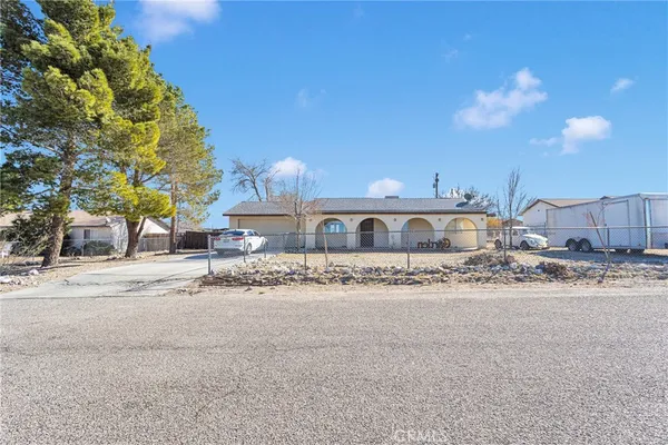 a view of a house with a yard next to a road
