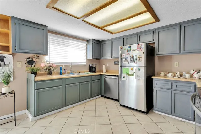 a kitchen with sink cabinets and refrigerator