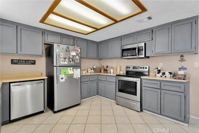 a kitchen with stainless steel appliances granite countertop a refrigerator sink and cabinets