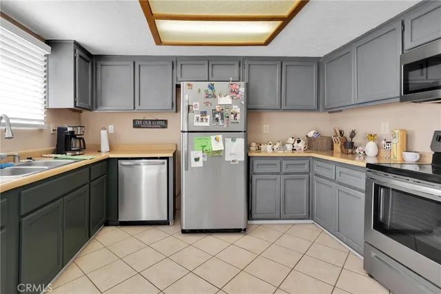 a kitchen with a sink a refrigerator and cabinets