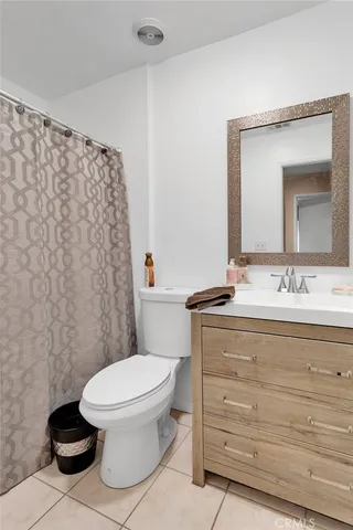 a bathroom with a toilet a sink and a mirror