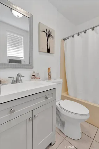 a bathroom with a sink toilet and mirror