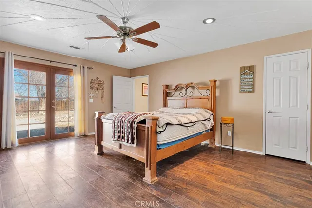 a spacious bedroom with a bed and a large window