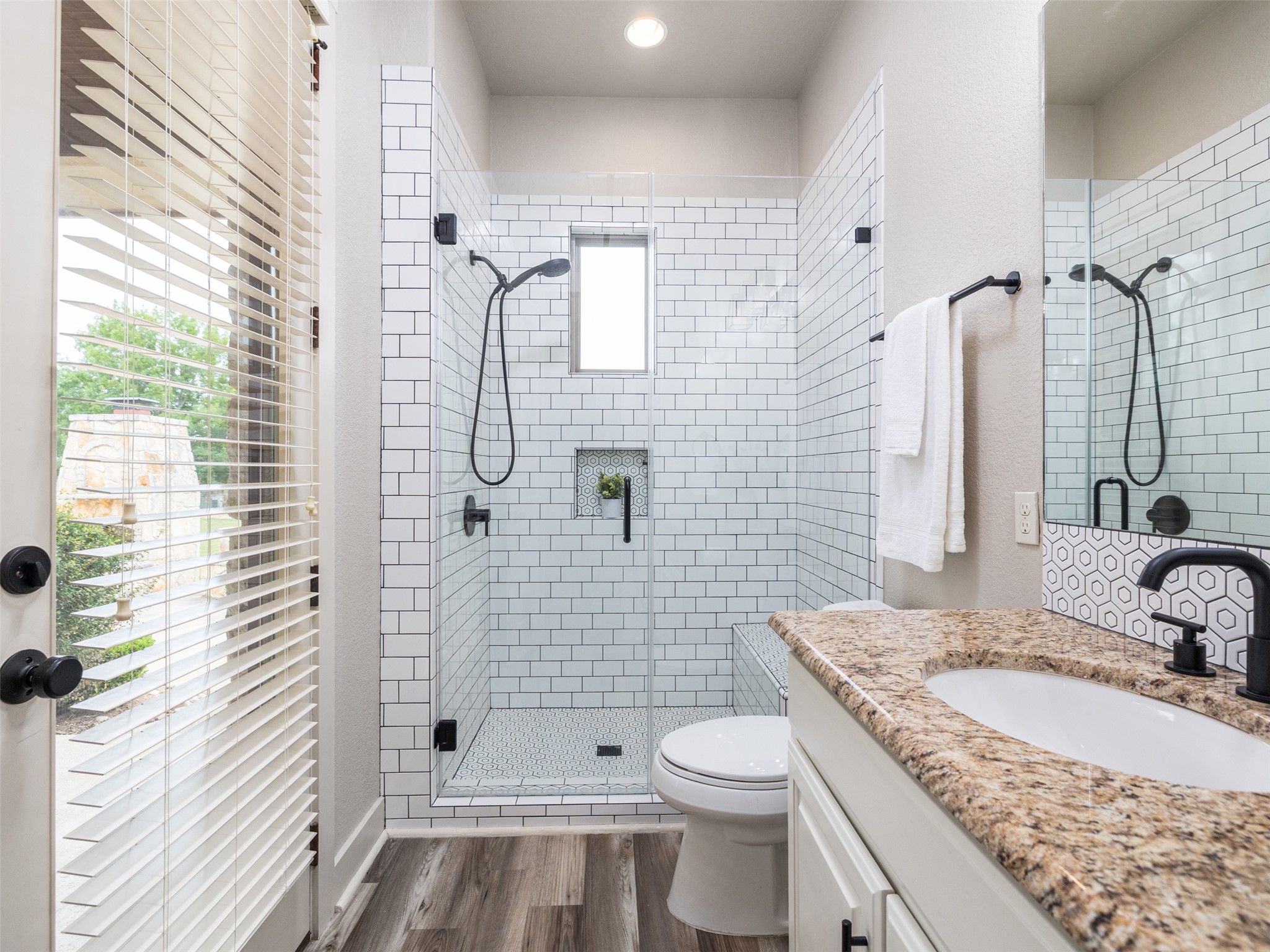 101 Aldea Street Georgetown, TX 78633 - Photo 18 of 40 This walk-in shower with recently updated tile surround is located next to a secondary bedroom in its own wing with access to the backyard perfect to access should you install a pool and spa!