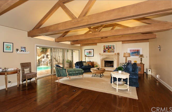 171 Monarch Bay Drive Dana Point, CA 92629 - Photo 3 of 12 a living room with furniture a fireplace and a flat screen tv