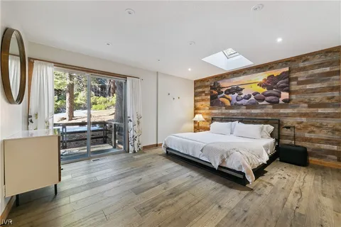 a bedroom with a bed and a large window