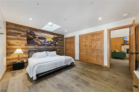 a bedroom with a large bed and a large window