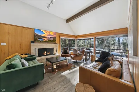 a living room with furniture fireplace and a large window