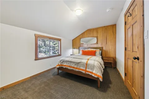 a bedroom with a bed lamp and a window