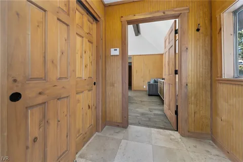 a view of a hallway with wooden shelves