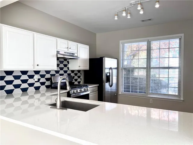 a large room with lots of appliances and windows