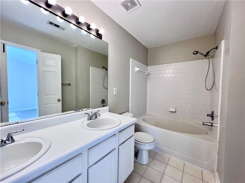 5770 Reps Trace Norcross, GA 30071 - Photo 7 of 9 a bathroom with a granite countertop sink a toilet a mirror and shower