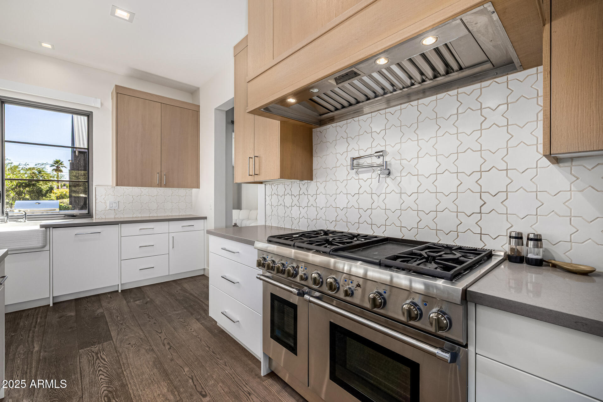 4535 North 49th Place Phoenix, AZ 85018 - Photo 23 of 75 a kitchen with granite countertop a stove and white cabinets