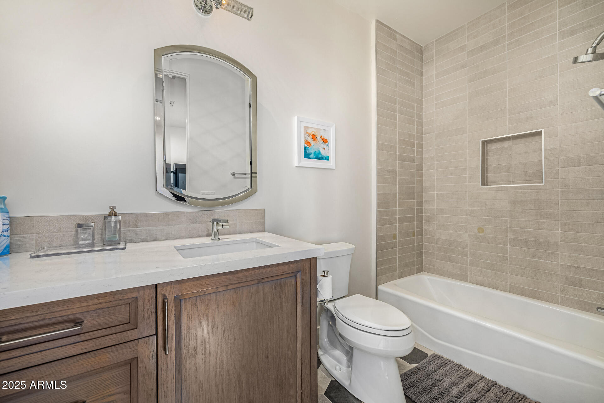 4535 North 49th Place Phoenix, AZ 85018 - Photo 51 of 75 a bathroom with a toilet a sink a mirror and bathtub