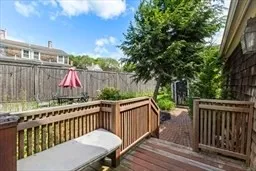 a view of a wooden deck and a backyard
