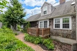 a view of a house with a small yard and flower plants