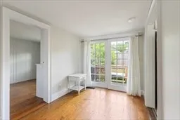 a view of an empty room with glass door and a window