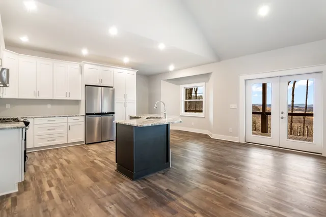 a view of a kitchen counter top space with granite countertop a sink and a counter top space