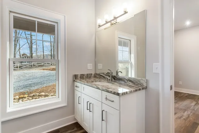 a view of a room with an empty space and wooden floor