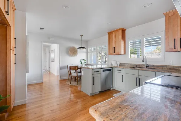 a kitchen with a sink stove top oven and cabinets