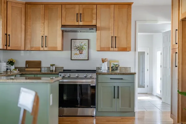 a kitchen with a sink cabinets and window