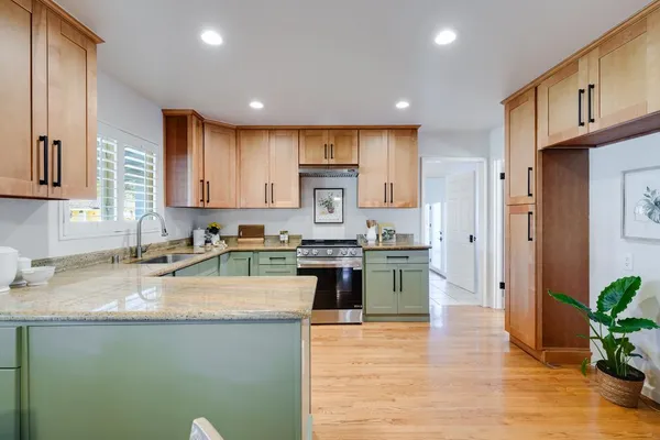 a dining room with a window a table and chairs