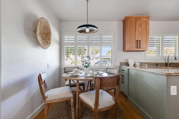 a living room with furniture a window and wooden floor
