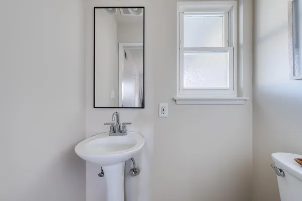 a living room with furniture a fireplace and a potted plant