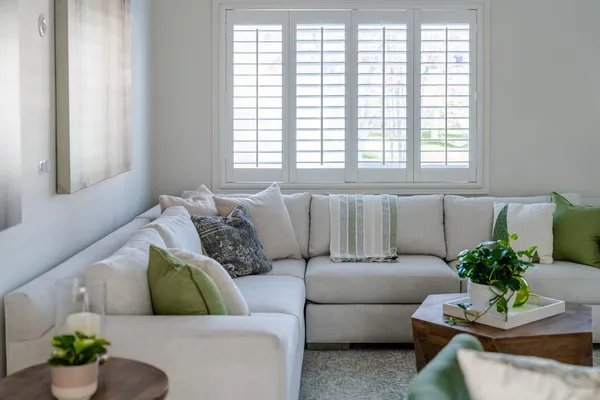 a bathroom with a sink mirror toilet and window