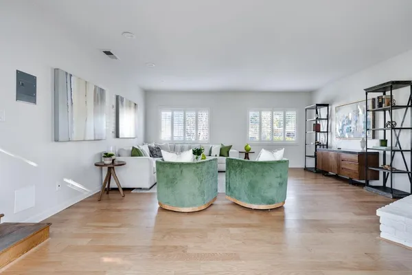 a bedroom with a bed and painting on the wall