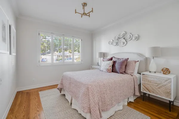a bedroom with a large bed and a balcony