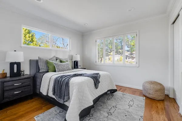 a view of a chair and table in backyard of the house