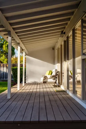 a vase of flowers sitting on a table with potted plants
