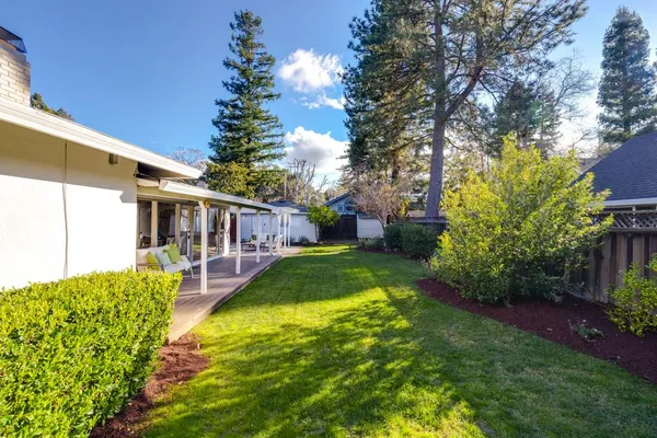 a front view of a house with a garden