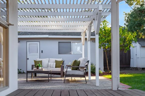 a view of a yard in front of a house with large tree