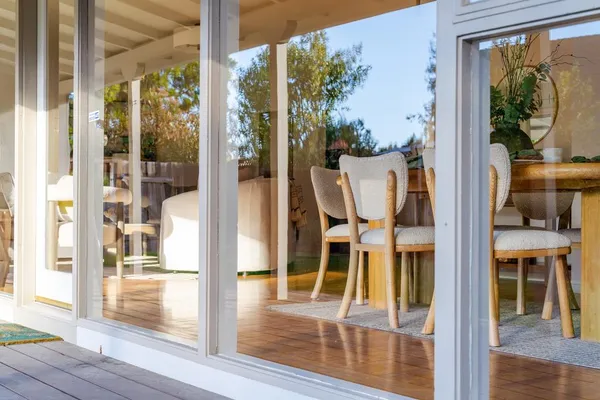 a view of a dining room with furniture and a floor to ceiling window