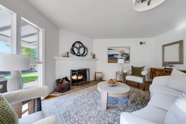 a living room with furniture and a fireplace