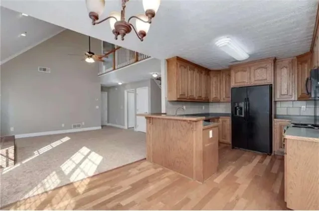 a kitchen with granite countertop a refrigerator oven a sink dishwasher and a refrigerator