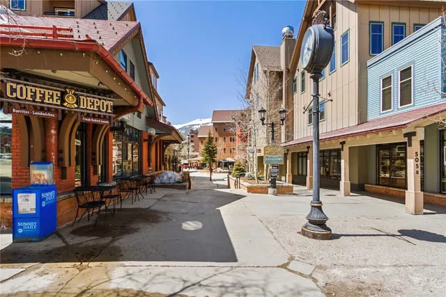 a living room with furniture a fireplace and a chandelier