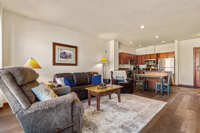 a living room with furniture and kitchen view