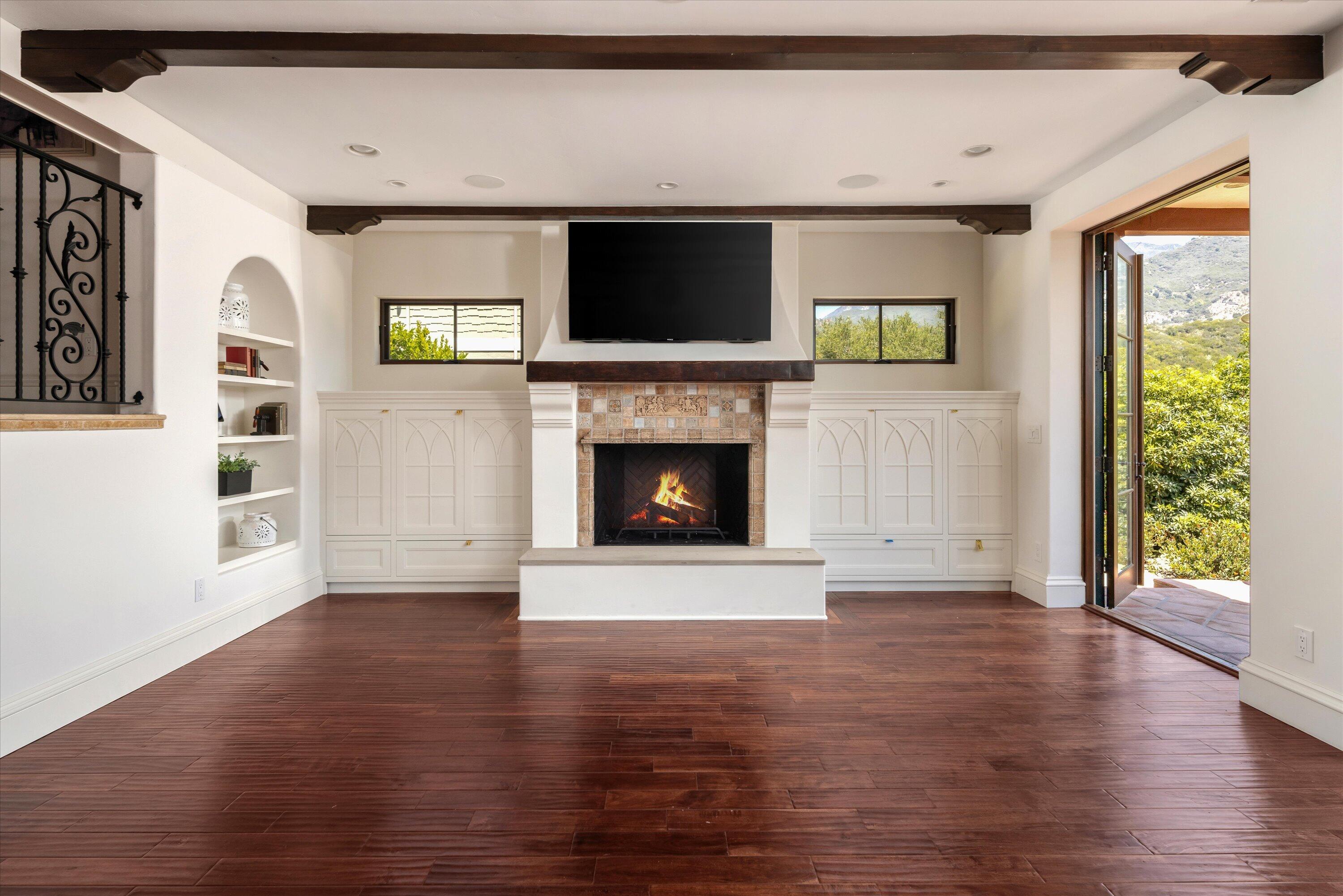 333 Conejo Road Santa Barbara, CA 93103 - Photo 12 of 43 a view of an empty room with a fireplace and a window