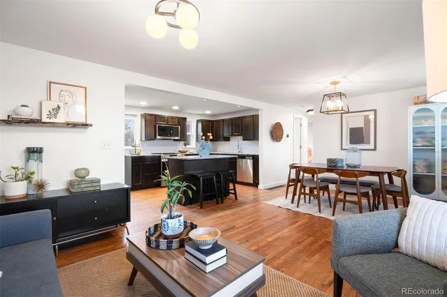 a living room with furniture kitchen view and a dining table