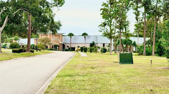 a swimming pool with yard and trees in the background