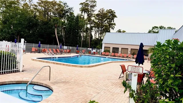a view of a house with swimming pool and sitting area