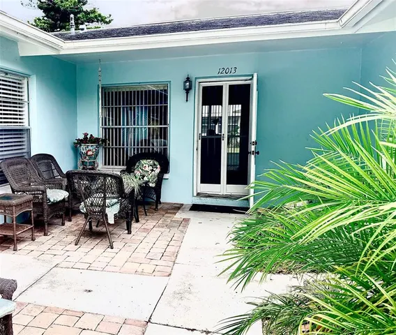 a view of backyard with outdoor seating and plants