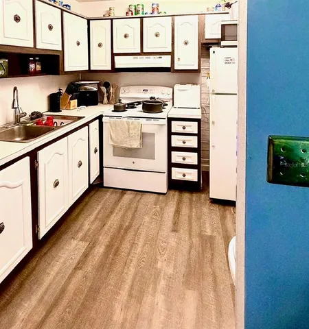 a kitchen with stainless steel appliances a refrigerator sink and cabinets