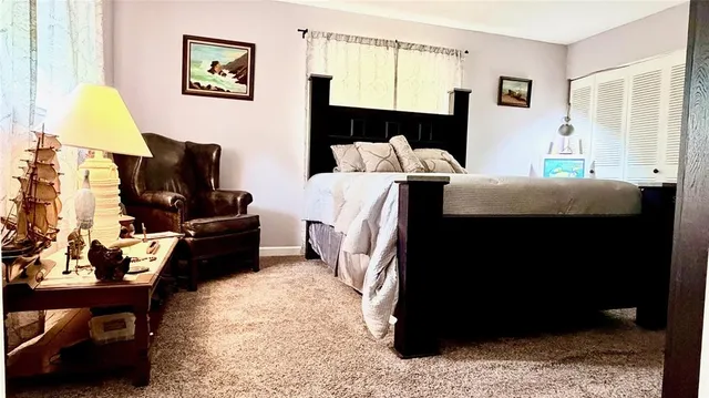 a bedroom with a bed and a television