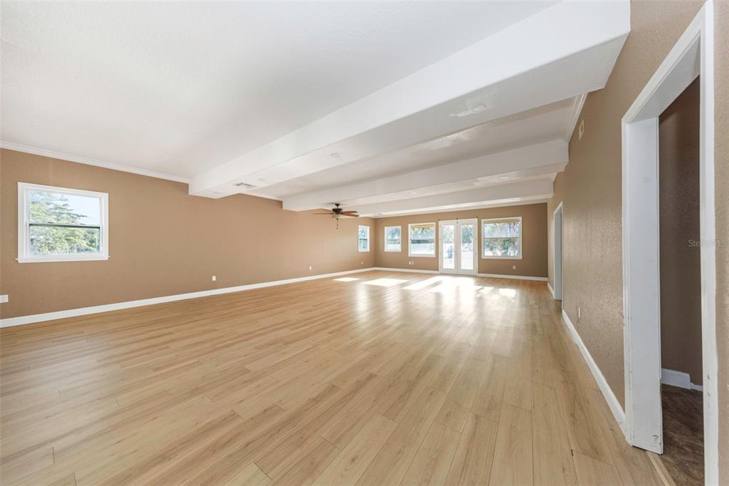20138 Bowman Road Spring Hill, FL 34610 - Photo 19 of 40 a view of empty room with wooden floor and fan