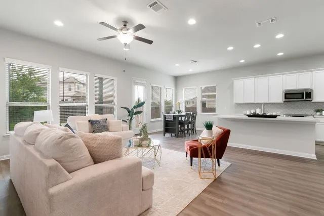 a living room with furniture and large windows